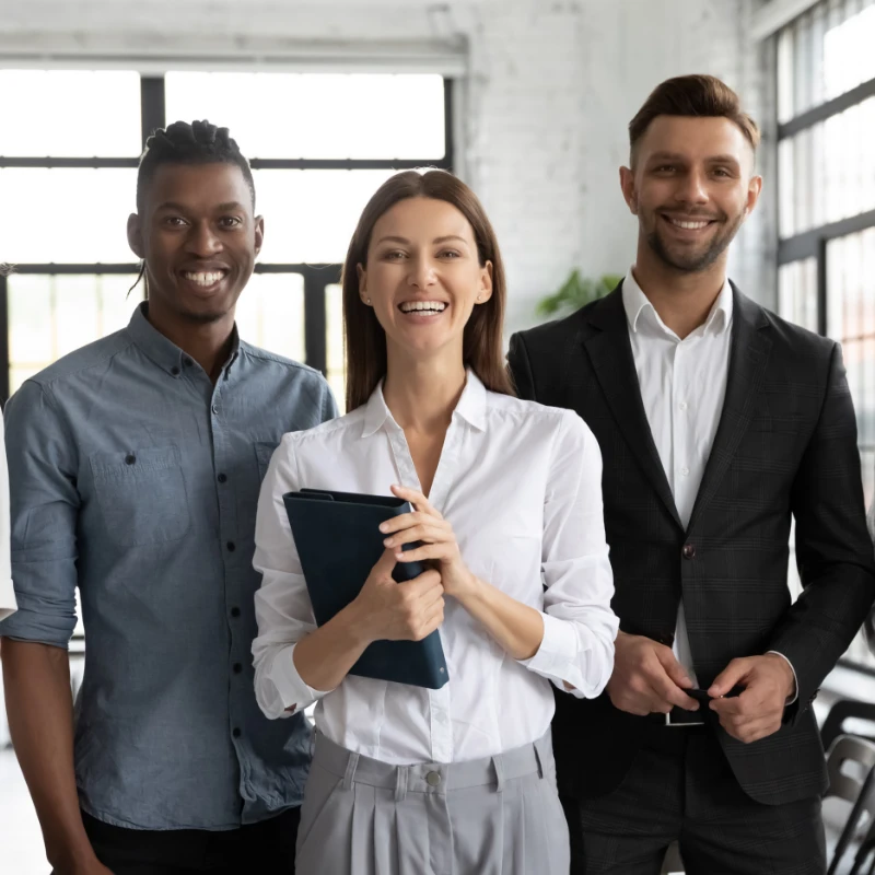 a group of employees standing together happy